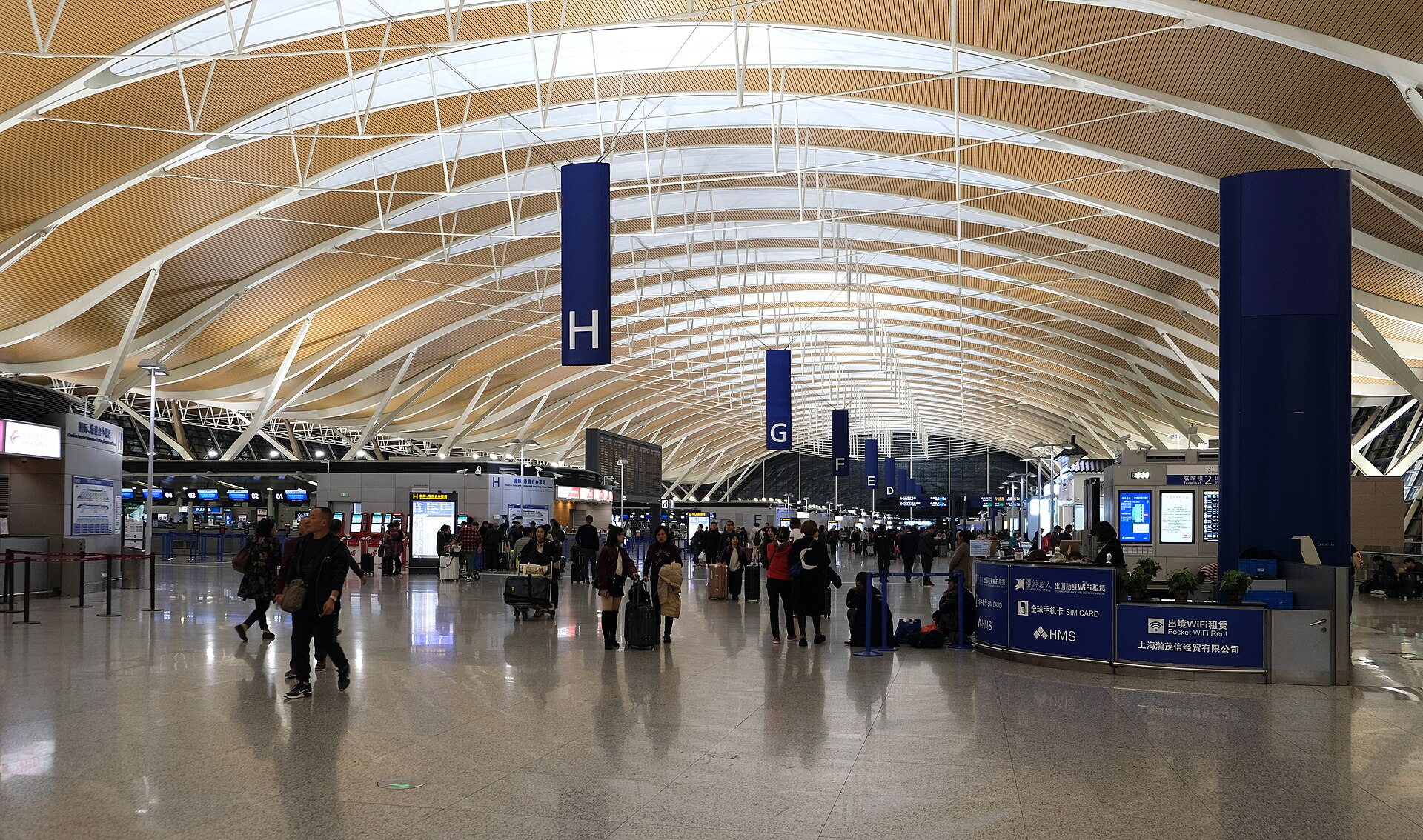 Travellers in the check-in hall at Shanghai Pudong Airport