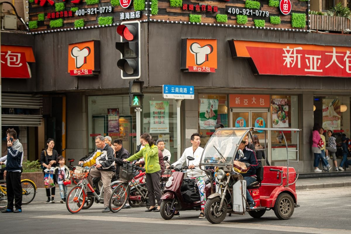 Pedestrians and cyclists at a Shanghai crossing