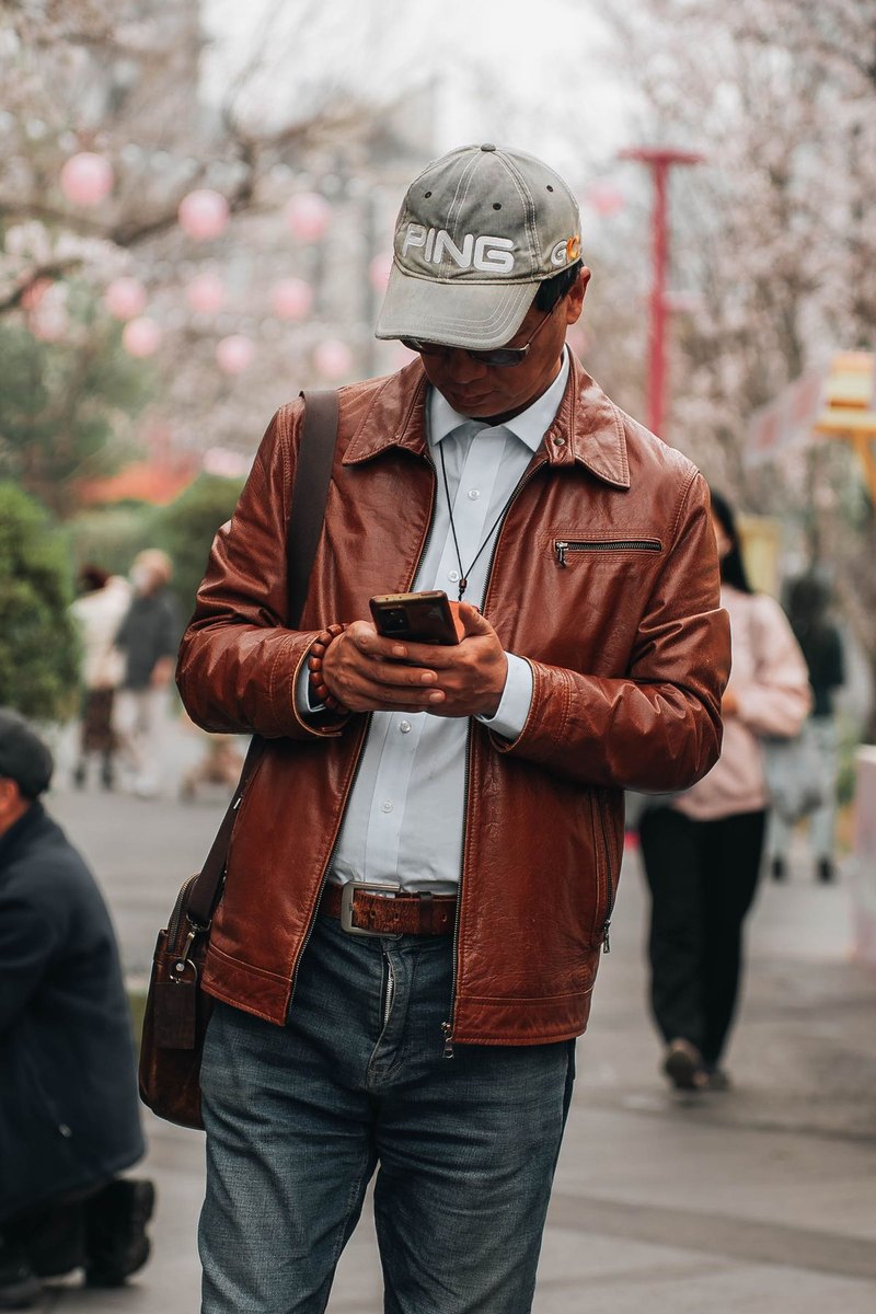 Person using a phone on a Chinese city street