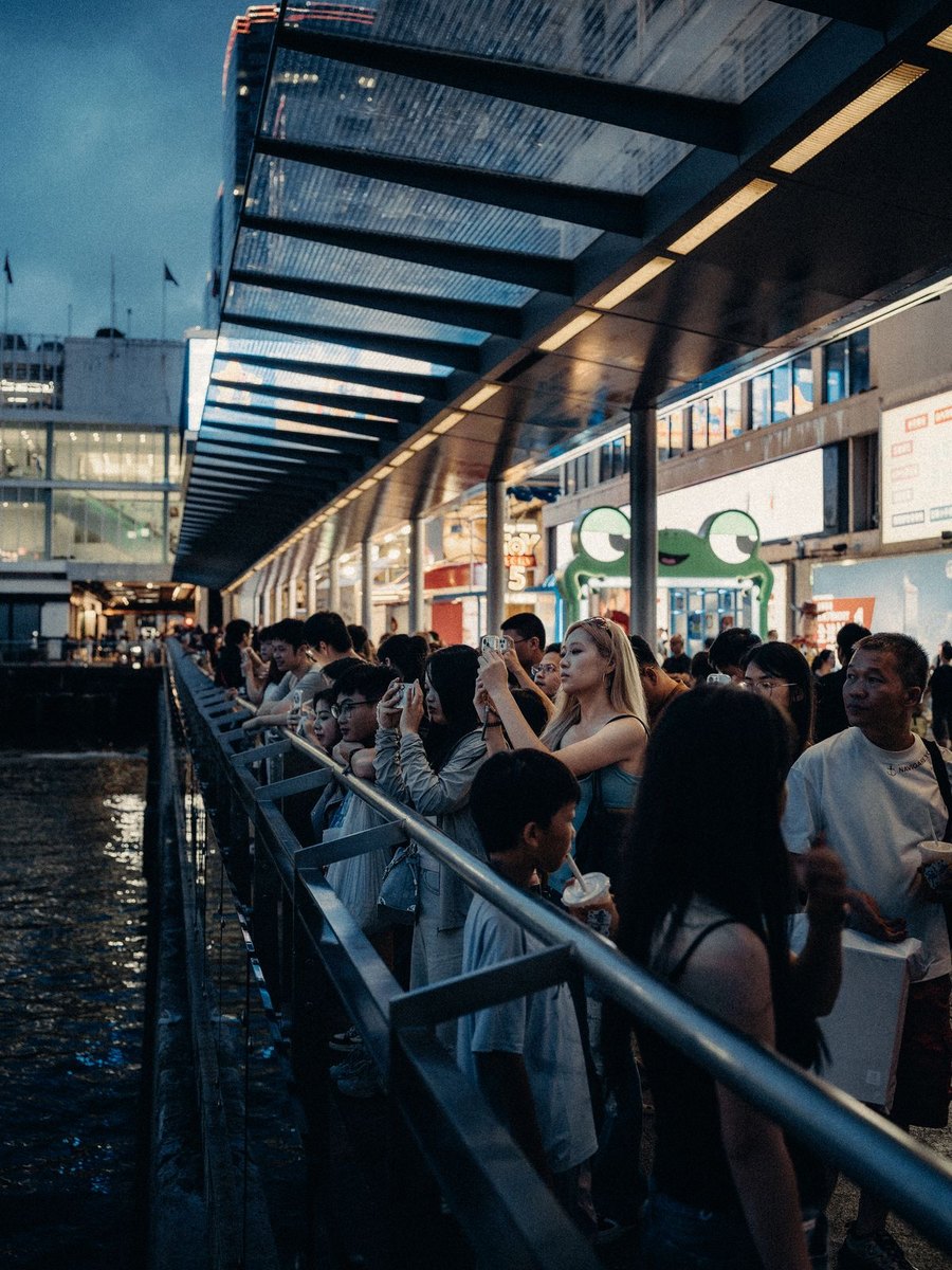 Visitors at the Hong Kong waterfront in the evening
